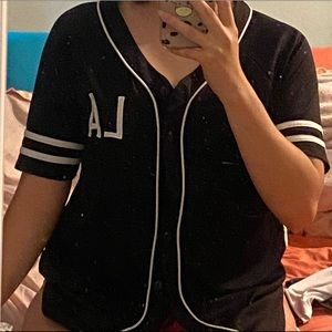 Medium jersey like shirt. Black with white lettering.